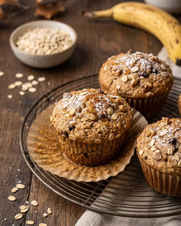 Freshly baked Gluten-Free Banana Oat Breakfast Muffins made with ripe bananas, oats, eggs, and honey, served on a cooling rack for a healthy American breakfast.
